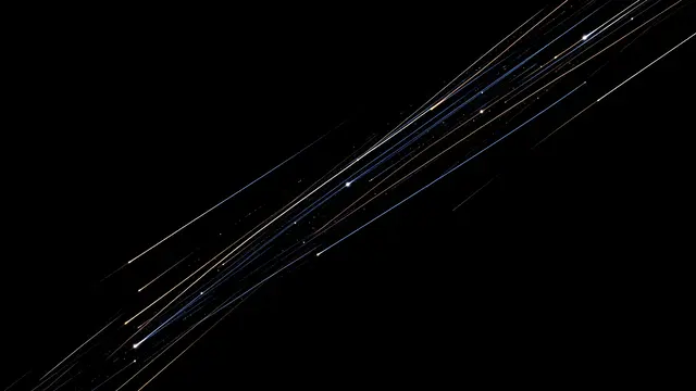 Multiple glowing diagonal shooting star streaks stretch across a solid pure black background