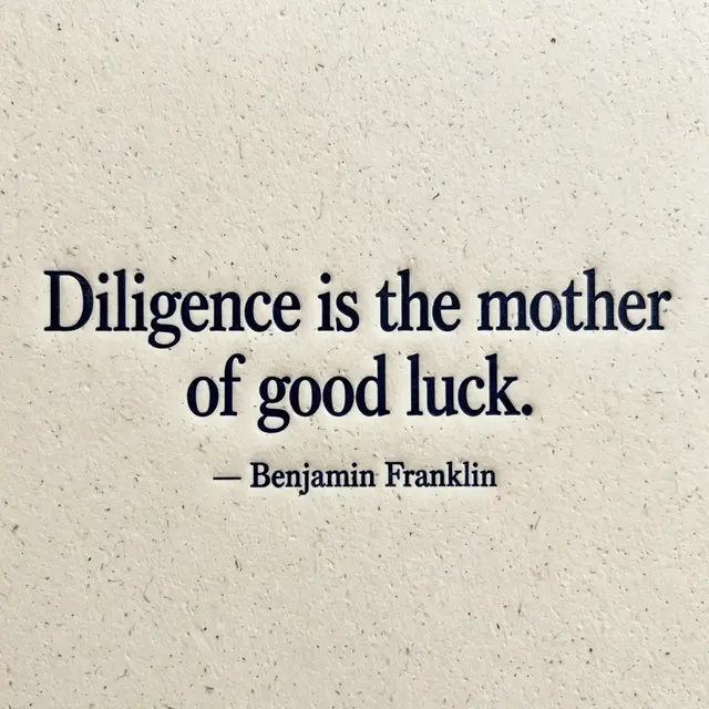 Deep navy debossed letterpress quote on textured cream cotton paper reading "Diligence is the mother of good luck.