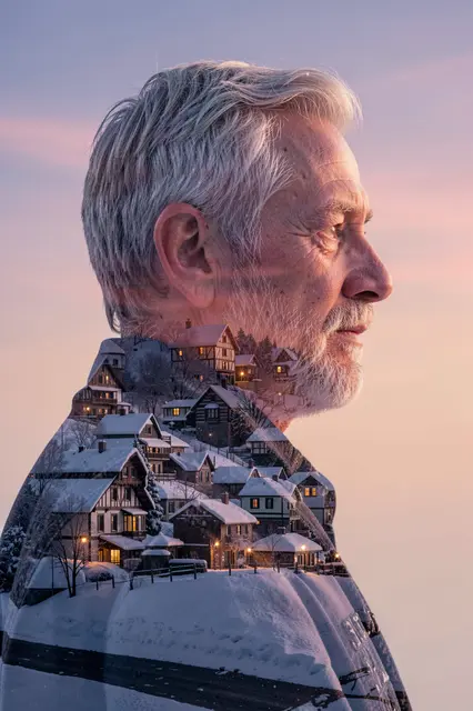 Double exposure profile portrait of an older man filled with a snowy alpine village at soft dusk
