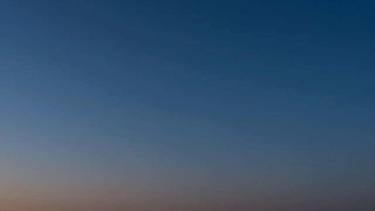 Smooth gradient of deep navy evening sky fading to a soft pale horizon band after dusk