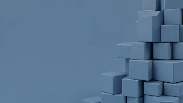 Stack of matte dusty blue cubes sits at the right edge with empty copy space on the left side