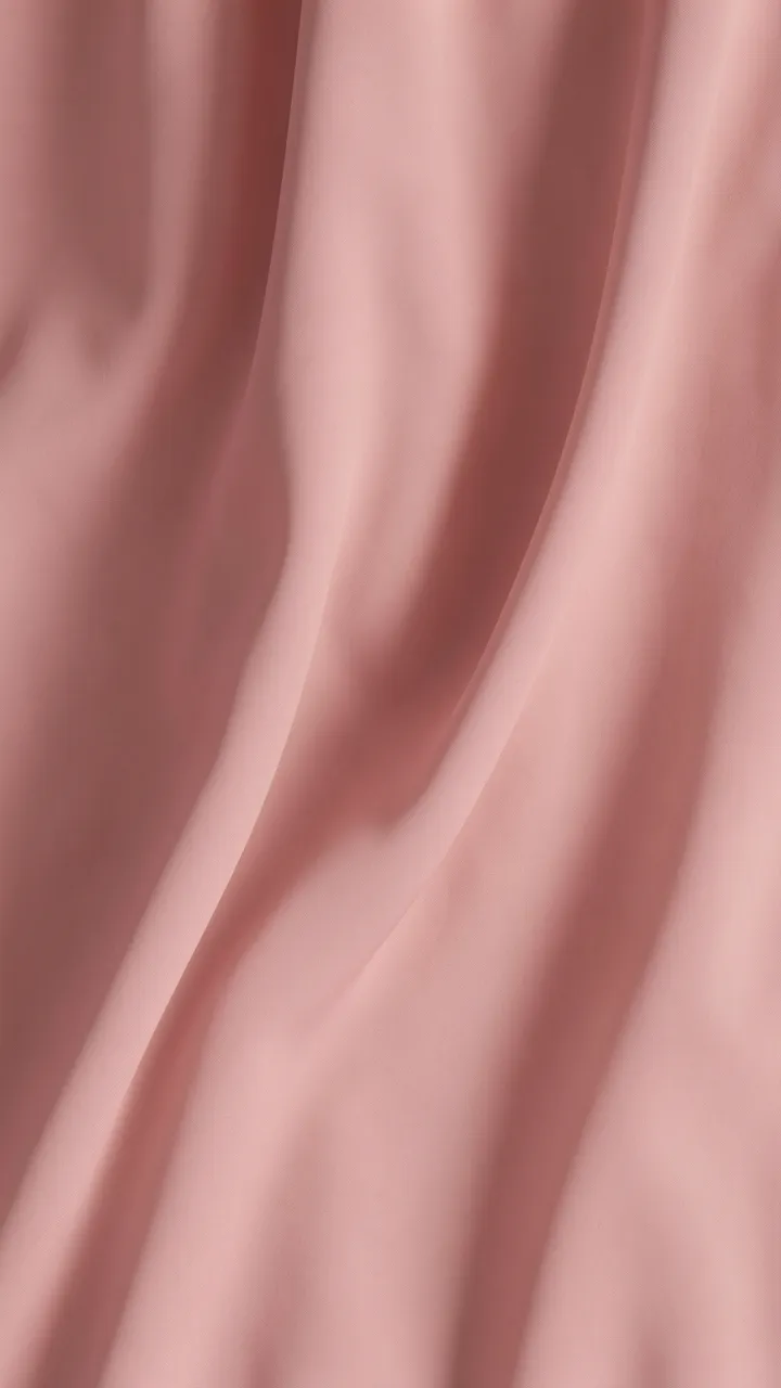 Soft draped dusty pink chiffon fabric flows in gentle curved folds under diffused light