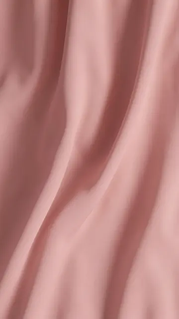 Soft draped dusty pink chiffon fabric flows in gentle curved folds under diffused light