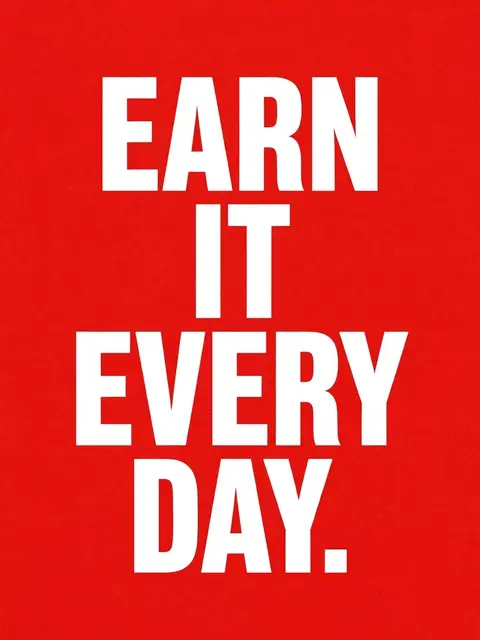 Bold stacked white condensed capital text reading "Earn it every day." centered on a solid bright red background