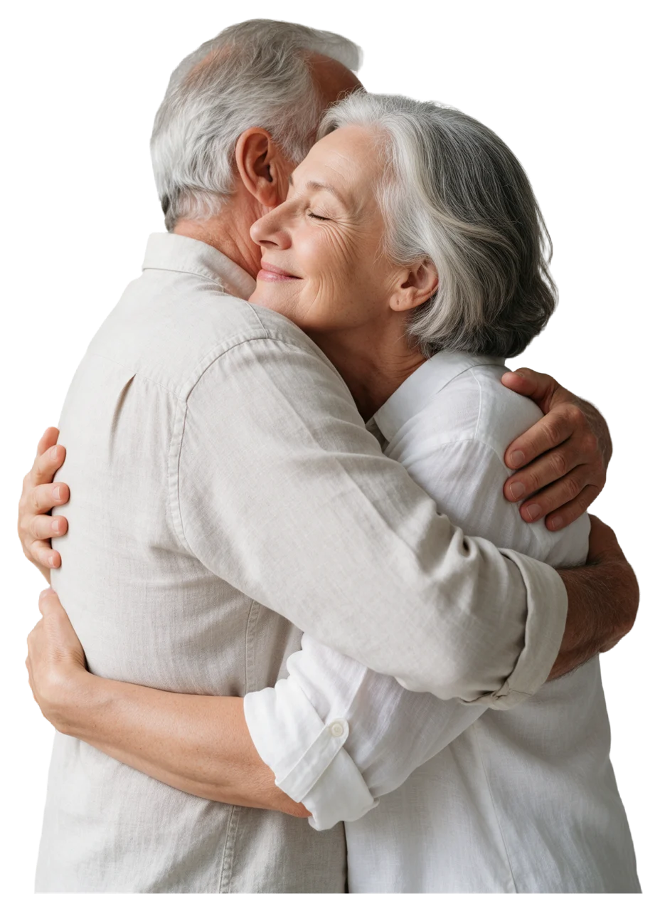 Side view of an elderly couple hugging closely, the woman resting her face on the man's shoulder with a soft smile