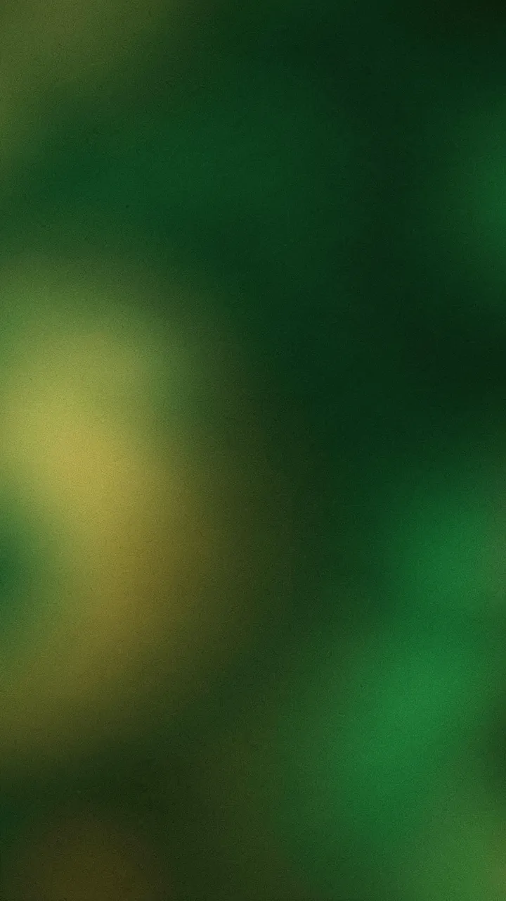 Vertical grainy blurred gradient wallpaper with glowing emerald and gold tones over a dark green base