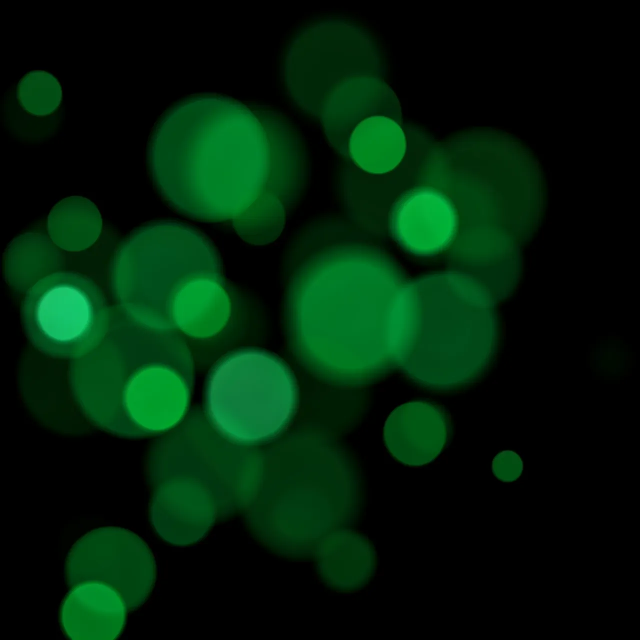Soft edged emerald green bokeh orbs scattered across a solid pure black background