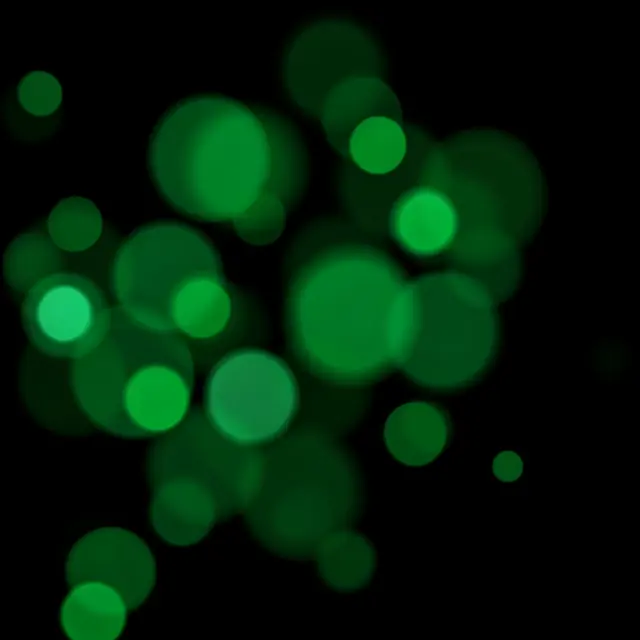 Soft edged emerald green bokeh orbs scattered across a solid pure black background