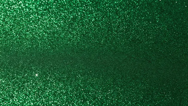 Full frame sparkling emerald green glitter with subtle brightness variation across the surface