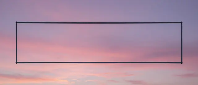 A thin empty rectangular dark frame sits against a soft pink and purple dusk sky