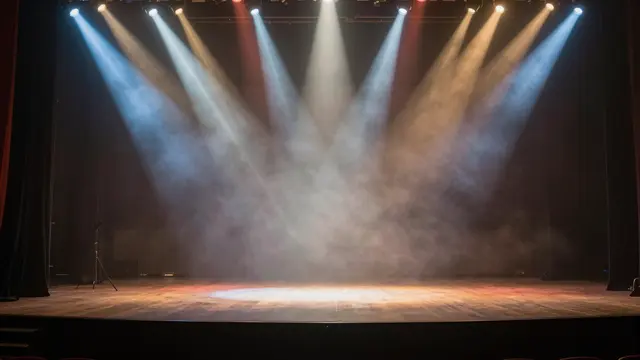 Empty theater stage with multicolored light beams cutting through hazy fog above a wooden floor