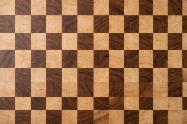 Top view of a full frame checkerboard end grain butcher block with alternating pale maple and dark walnut wood squares
