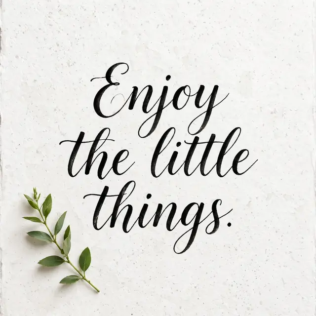 Black brush lettering reading "Enjoy the little things." sits with a small green leaf sprig on textured white watercolor