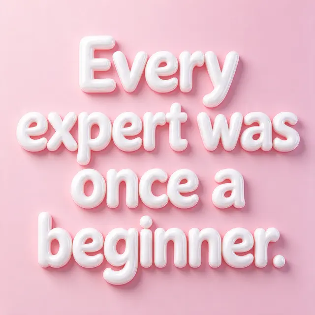 Glossy white 3D bubble letter quote reading "Every expert was once a beginner." set against a soft pastel pink background