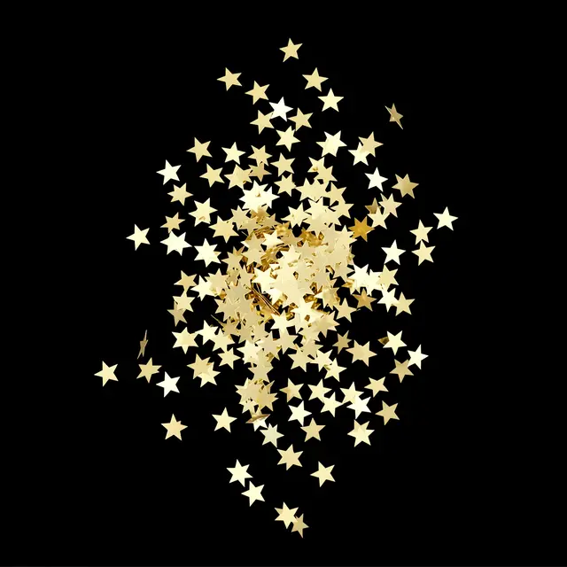 Pale gold star-shaped foil confetti falls against a solid pure black background