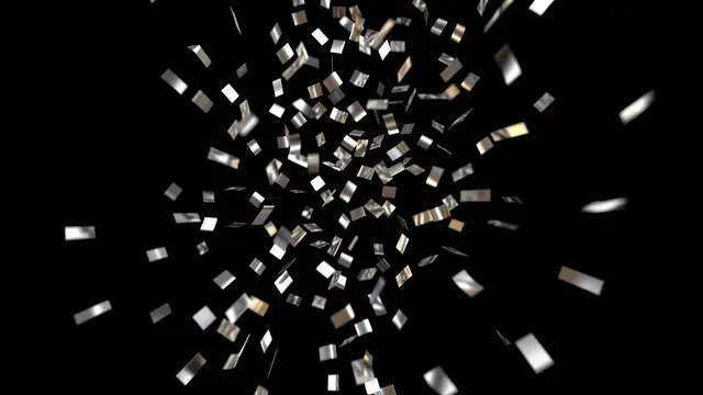 Shiny silver and gold metallic confetti falls with motion blur against a solid pure black background