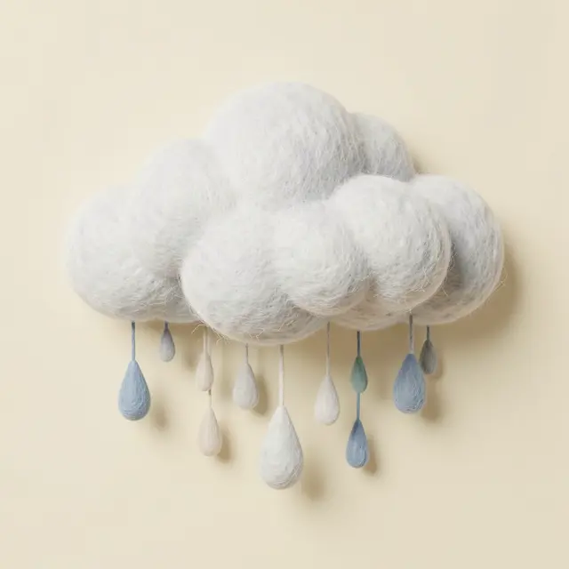 A soft textured 3D felt cloud hangs with dangling felt raindrops against a plain cream background