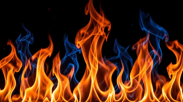 Swirling bright orange and cool blue abstract flames rise against a solid black background