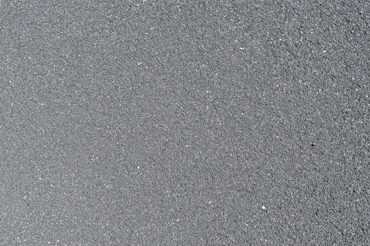 Top-down view of uniform fine gray gravel texture filling the entire frame