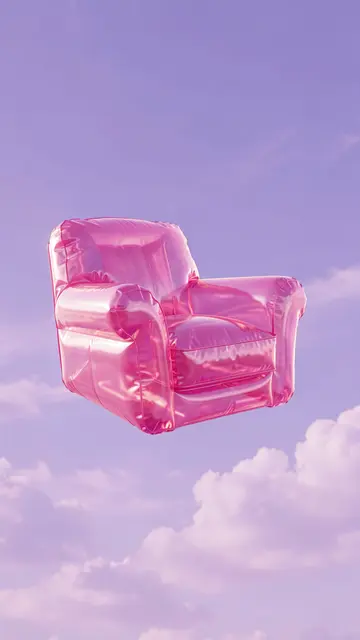 Translucent pink inflatable armchair floats against a soft lilac cloudy sky