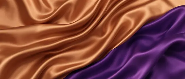 Smooth draped copper and deep plum silk form soft, flowing folds across the frame.
