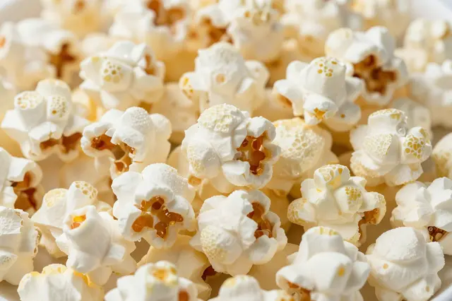 A tight close-up of fluffy popped popcorn kernels filling the entire frame
