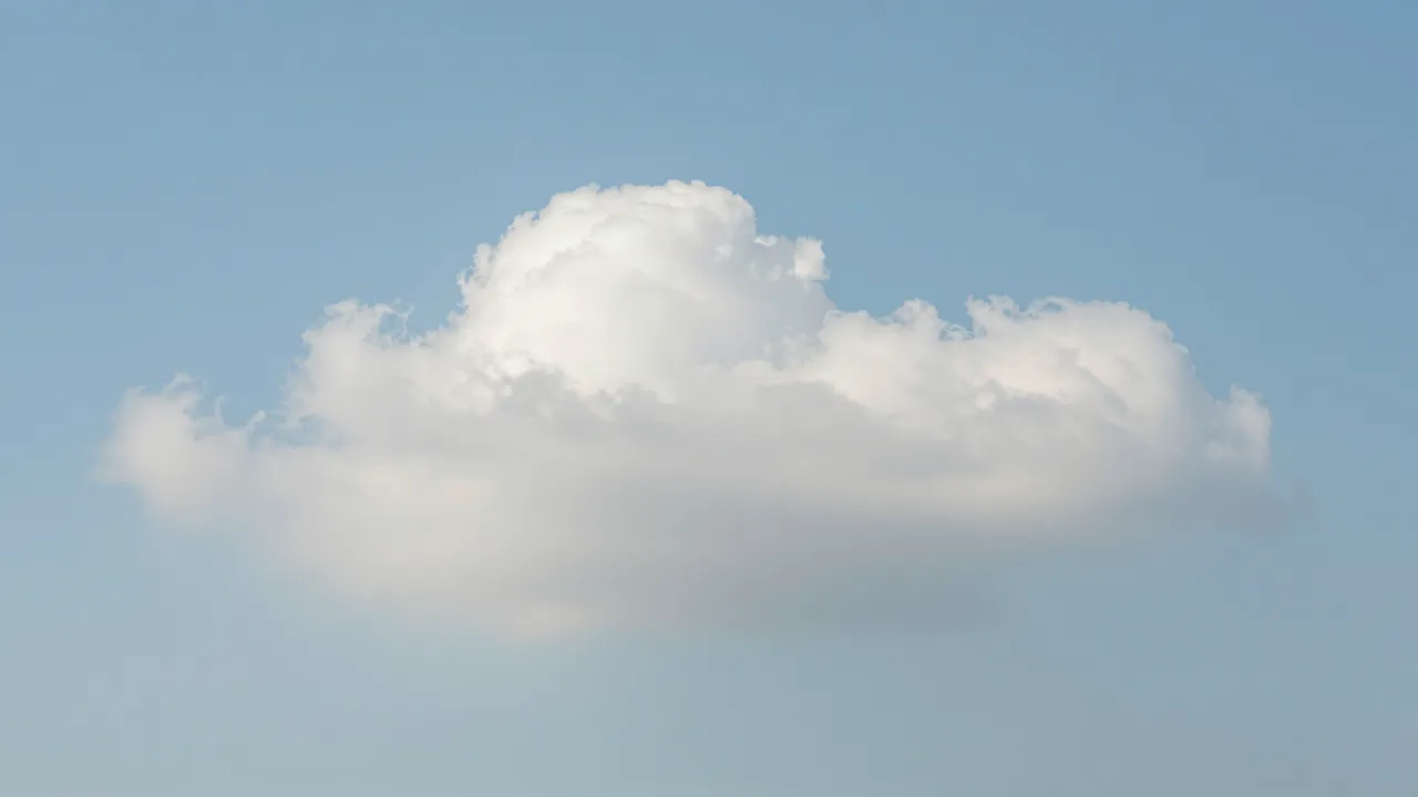 A single soft fluffy white cumulus cloud floats against a smooth pastel blue sky
