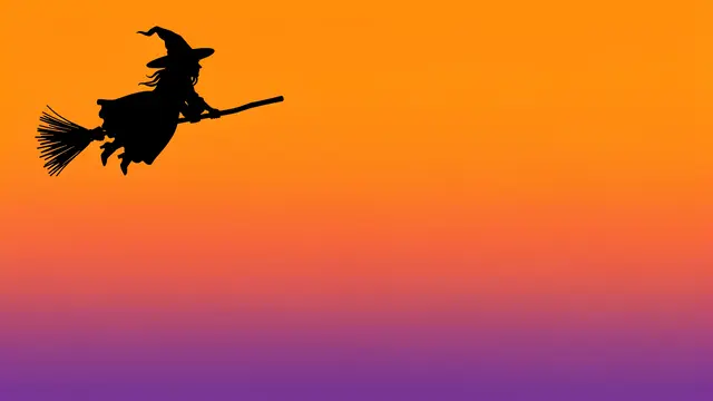 Black witch silhouette on a broom against a smooth orange to purple gradient sky with empty copy space