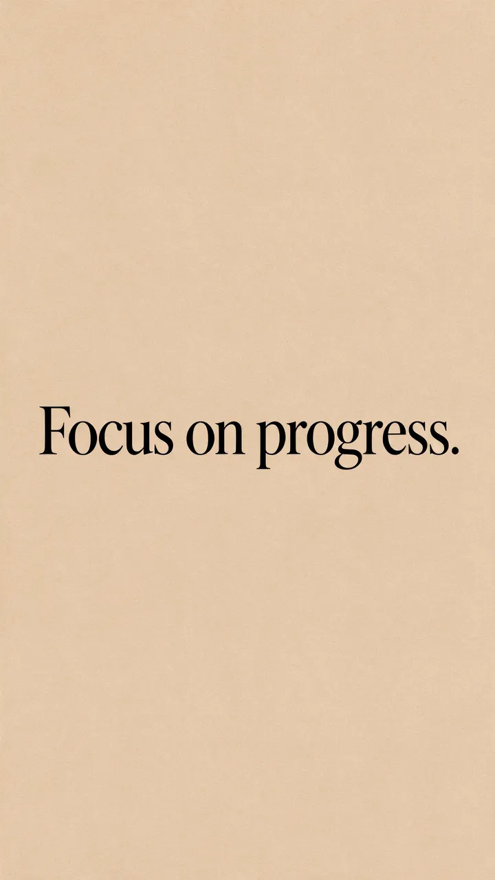 The text "Focus on progress." in black serif type centered on a warm sand beige vertical background.