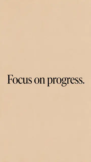 The text "Focus on progress." in black serif type centered on a warm sand beige vertical background.