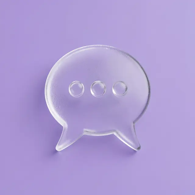 A frosted transparent 3D chat bubble icon with typing dots rests on a solid lavender background