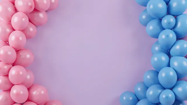 Pink balloons on the left and blue balloons on the right frame a blank lilac center background