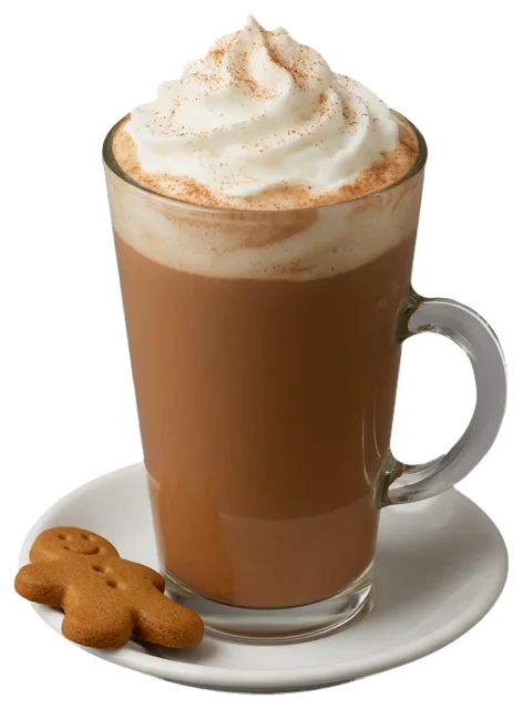 Tall glass mug of gingerbread latte topped with whipped cream and cinnamon, next to a gingerbread man cookie on a white
