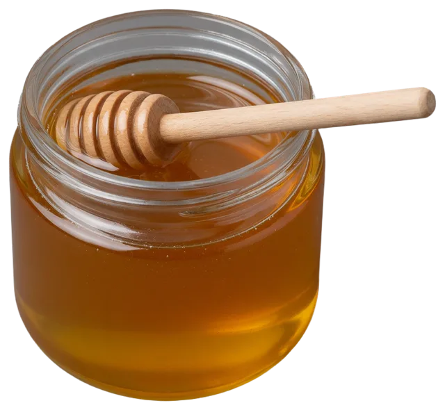 An open clear glass jar of golden honey with a wooden honey dipper resting across its rim.