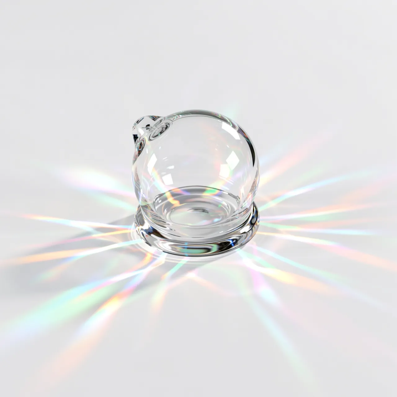 Clear transparent glass shape casts rainbow prismatic light across a plain white surface
