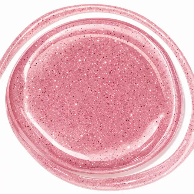 A glossy swirled smear of sparkly pink glitter sauce on a transparent background