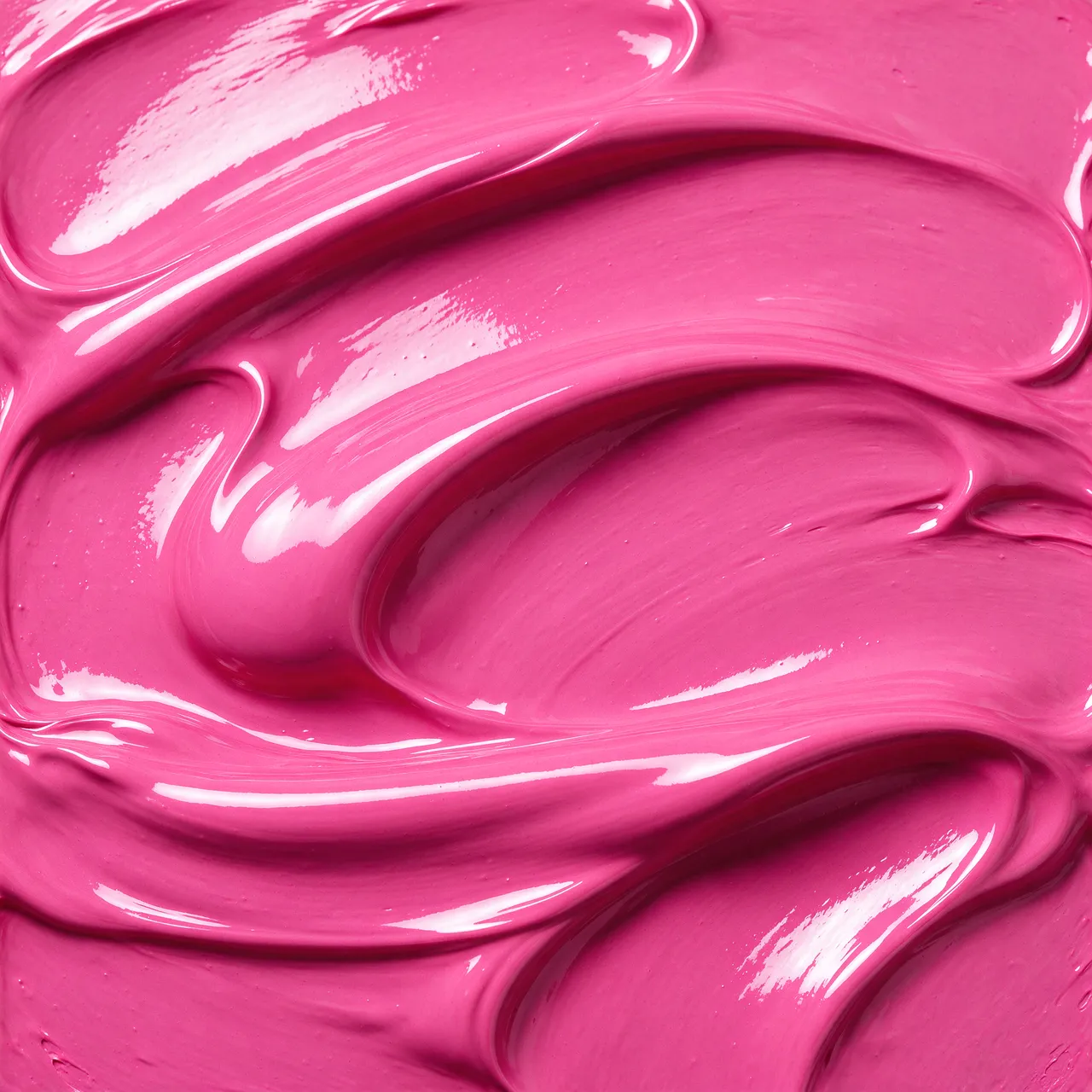 Close-up of thick, wet glossy hot pink paint with smooth folded swirls and bright reflective highlights filling the frame