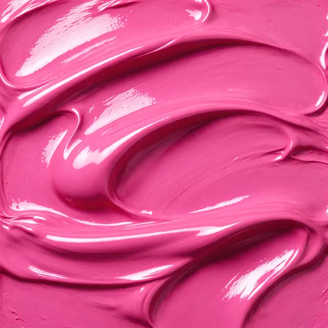 Close-up of thick, wet glossy hot pink paint with smooth folded swirls and bright reflective highlights filling the frame