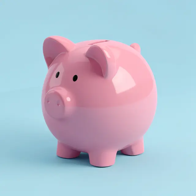 A glossy pink piggy bank sits against a soft pastel light blue background.