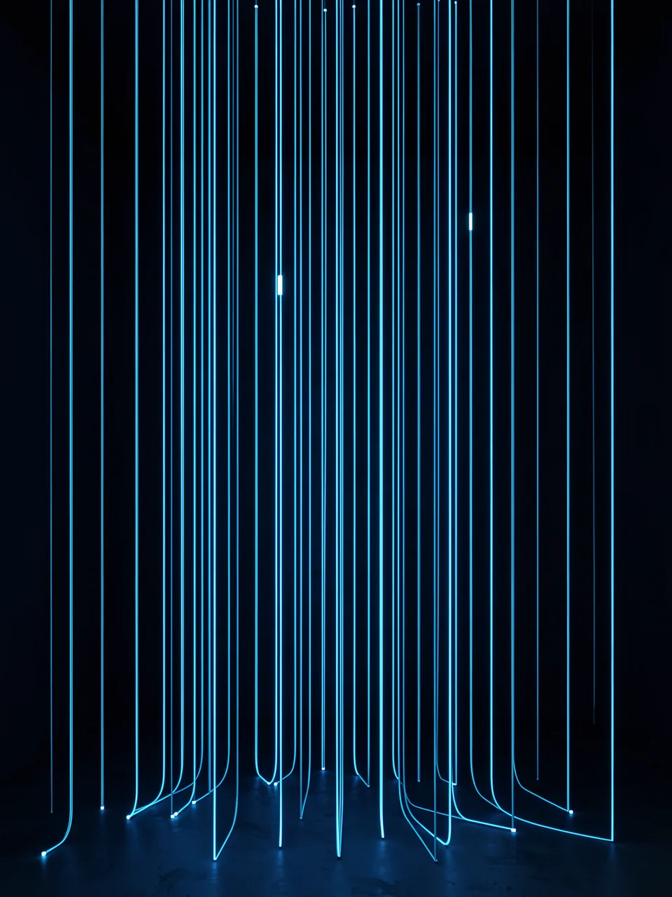 Vertical glowing blue light threads hang like a curtain in a dark room, with a few brighter threads.