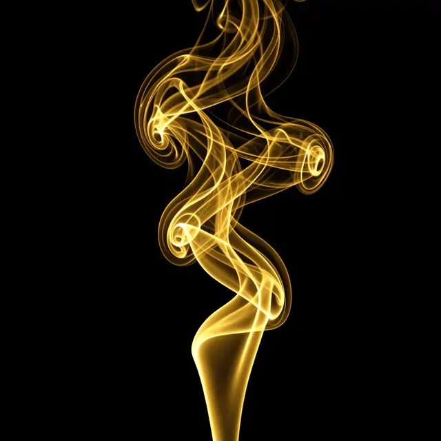 Wispy glowing golden smoke curls and twists against a solid pure black background