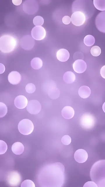 Soft glowing lilac and pale orbs drift across a smooth violet haze background