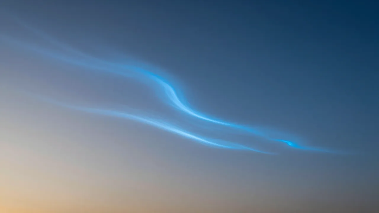 Wispy electric blue noctilucent clouds drift across a gradient twilight sky after sunset