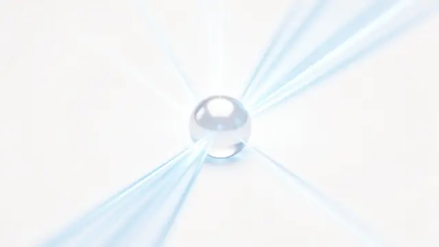 A translucent glowing pearl sits at the center of soft blue light rays against a plain white background