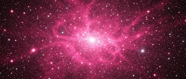 An ultrawide view of a cosmic stellar nursery filled with wispy pink gas and dense bright stars against dark space