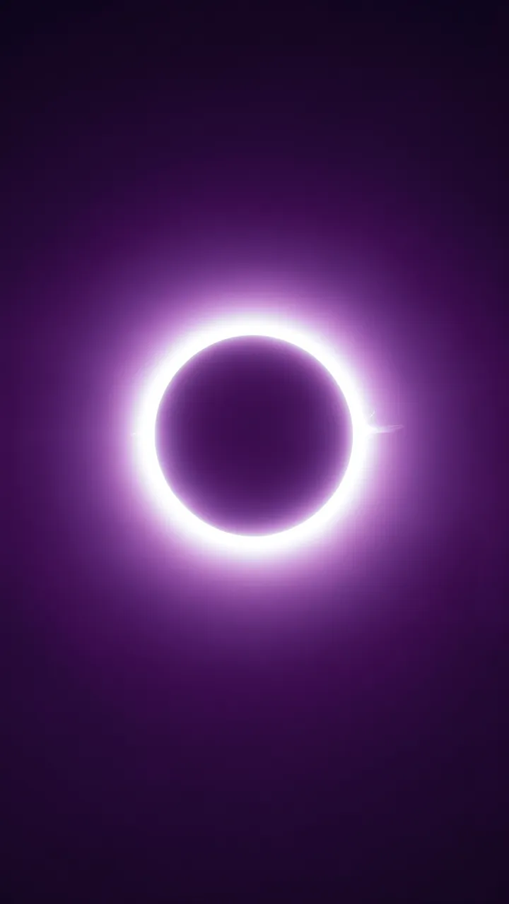 A bright white annular solar eclipse glows against a smooth dark violet gradient sky