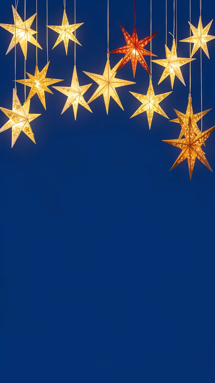 Lit paper star lanterns hang at varying heights against a deep blue empty background.
