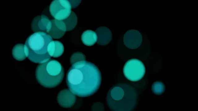 Soft glowing teal and turquoise bokeh circles scattered across a pure black background