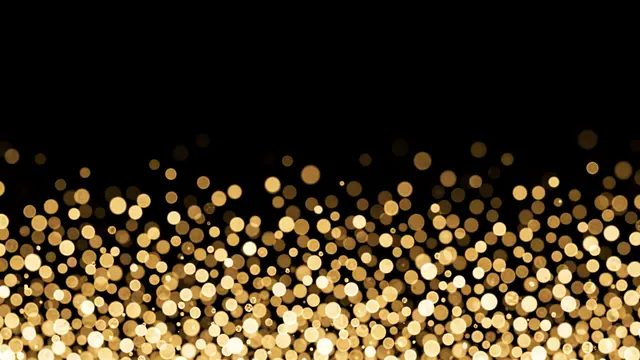 Warm golden champagne-style bokeh dots gather in the lower frame and fade upward on a pure black background