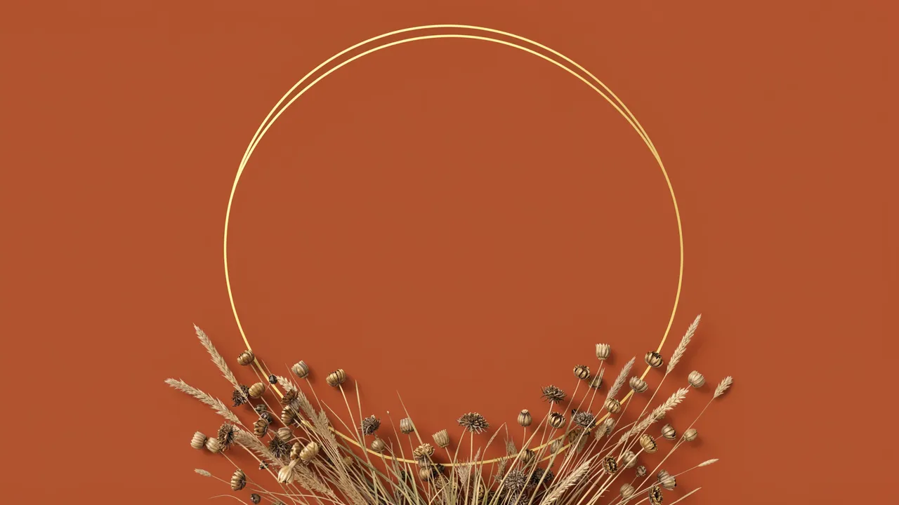 A thin double gold circle frame with dried grasses and seed heads on a rust orange background, empty inside the frame.